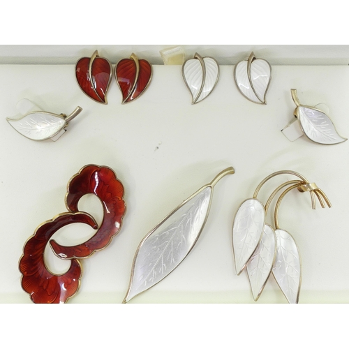 941 - A collection of silver gilt  Norwegian enamel jewellery to include a white leaf brooch and earrings ... 