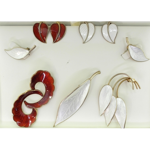 941 - A collection of silver gilt  Norwegian enamel jewellery to include a white leaf brooch and earrings ... 