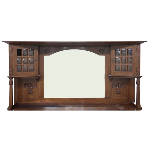 2040 - AN  OAK ARTS & CRAFTS MIRROR BACK SIDEBOARD bevelled mirror back flanked by glazed cabinets on s... 