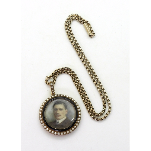 2793 - A 15CT PORTRAIT MINIATURE PENDANTthe portrait of a young man, is encircled with black enamel and pea... 