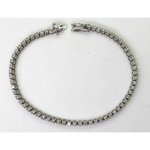 2813 - A DIAMOND LINE BRACELETmounted in 9ct white gold, set with sixty-two x 0.025ct brilliant cut diamond... 