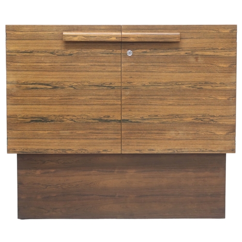 2092 - A MID 20TH CENTURY ROSEWOOD TREVOR CHINN F.S.I.A.D. FOR GORDON RUSSELL TWO DOOR CABINET with shaped ... 