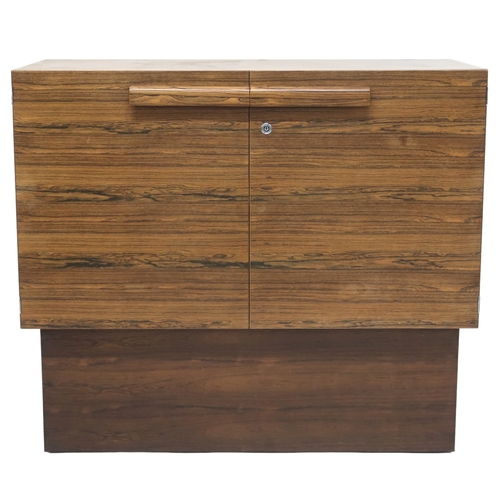 2092 - A MID 20TH CENTURY ROSEWOOD TREVOR CHINN F.S.I.A.D. FOR GORDON RUSSELL TWO DOOR CABINET with shaped ... 