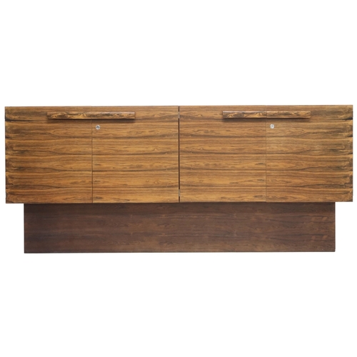 2093 - A MID 20TH CENTURY ROSEWOOD TREVOR CHINN F.S.I.A.D. FOR GORDON RUSSELL SIDEBOARD with four cabinet d... 