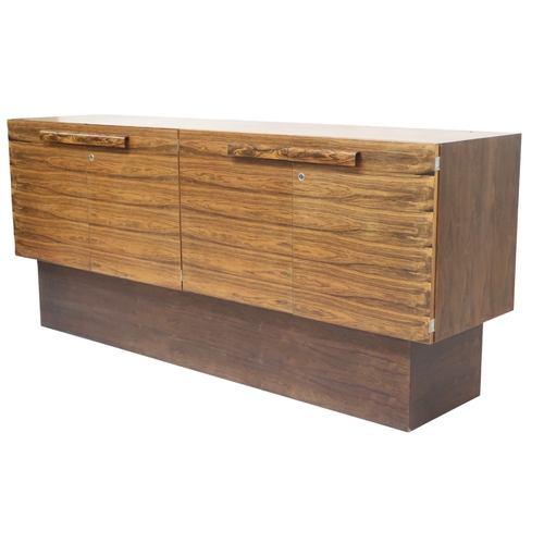 2093 - A MID 20TH CENTURY ROSEWOOD TREVOR CHINN F.S.I.A.D. FOR GORDON RUSSELL SIDEBOARD with four cabinet d... 