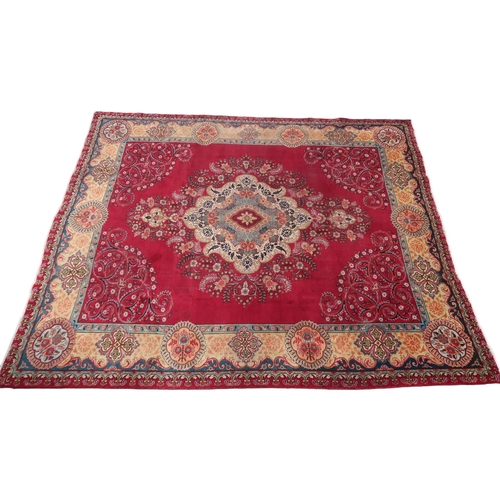 2137 - A RED GROUND TRADITIONAL PERSIAN TABRIZ with bespoke multicoloured central medallion and floral patt... 