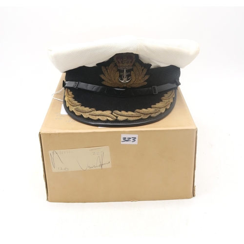 323 - A post-War Royal Navy officer's cap by Gieves Ltd. of London, with bullion oak leaf embroidery to pe... 