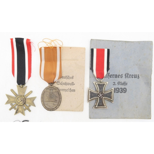 328 - A collection of German military medals, comprising Third Reich West Wall Medal, retaining issue pack... 