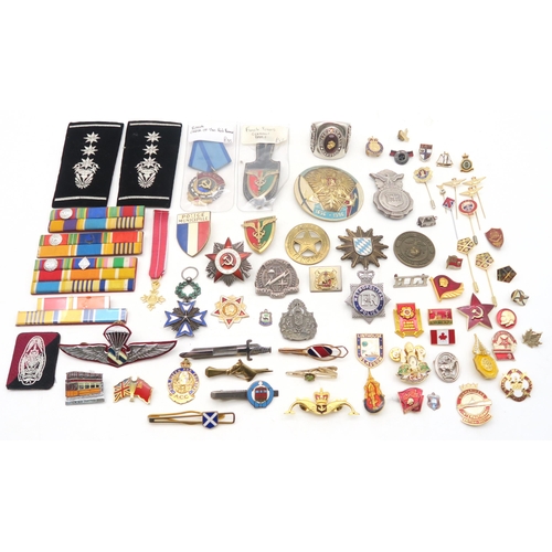 329 - Assorted military medals and badges, to include a French Order of the Black Star medal; Russian Orde... 