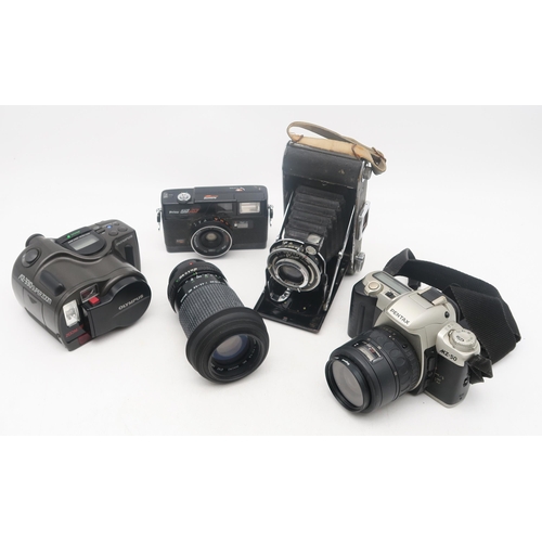 378 - A Canon A1 camera, fitted with a Canon FD 50mm 1:1.8 lens; a Zenit EM camera, fitted with a Helios 4... 