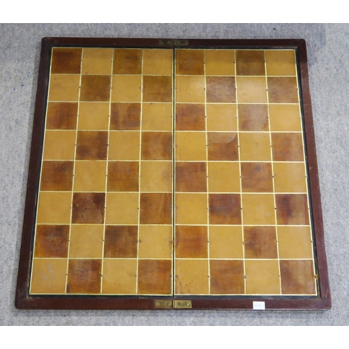 409 - A chess set, with kings measuring approx. 8.5cm in height;  with a large folding leather board measu... 