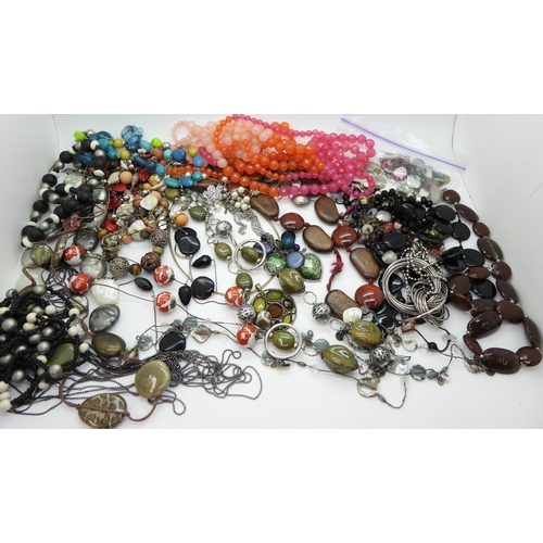 946 - A collection of statement beads and necklaces in a vanity case with applied leaves