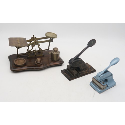 382 - A lot comprising two desk embossers and a set of  postal scales