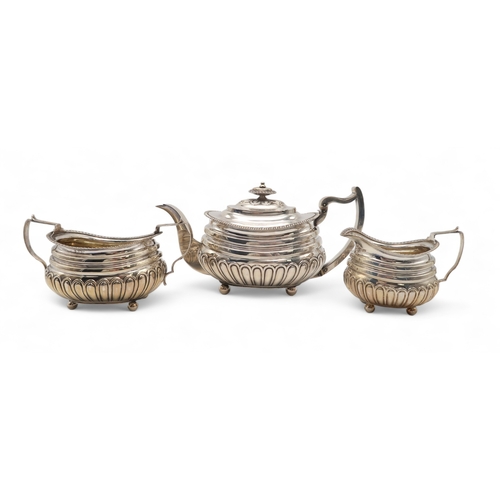 2548 - A GEORGE III THREE PIECE SILVER TEA SERVICEby Solomon Hougham, London 1813, of squat shaped form, th... 