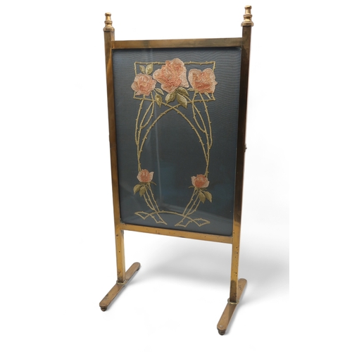 2330 - A GLASGOW SCHOOL ARTS AND CRAFTS BRASS FRAMED FIRE SCREENof slim proportions, with silk embroidered ... 