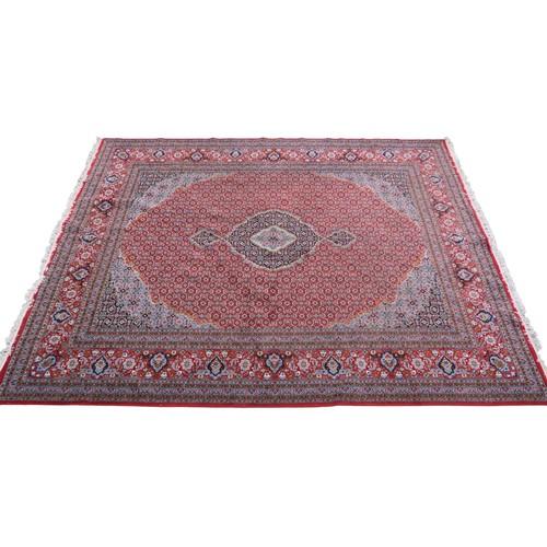 2138 - A RED GROUND TRADITIONAL BIJAR CARPET with dark and light blue central medallion and matching spandr... 