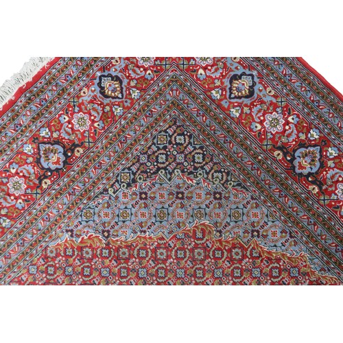 2138 - A RED GROUND TRADITIONAL BIJAR CARPET with dark and light blue central medallion and matching spandr... 