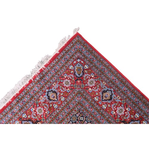 2138 - A RED GROUND TRADITIONAL BIJAR CARPET with dark and light blue central medallion and matching spandr... 