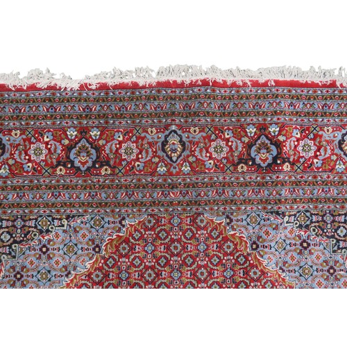 2138 - A RED GROUND TRADITIONAL BIJAR CARPET with dark and light blue central medallion and matching spandr... 