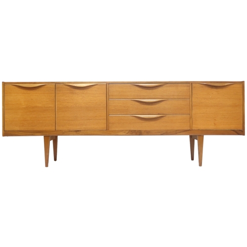 2099 - A MID 20TH CENTURY TEAK VICTOR WILKINS FOR G PLAN SIDEBOARD with three graduating drawers flank... 