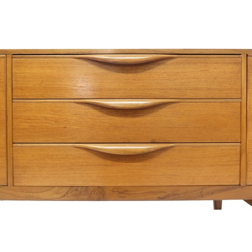 2099 - A MID 20TH CENTURY TEAK VICTOR WILKINS FOR G PLAN SIDEBOARD with three graduating drawers flank... 