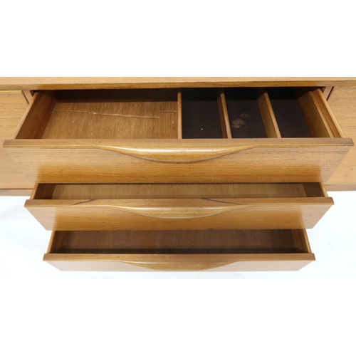 2099 - A MID 20TH CENTURY TEAK VICTOR WILKINS FOR G PLAN SIDEBOARD with three graduating drawers flank... 