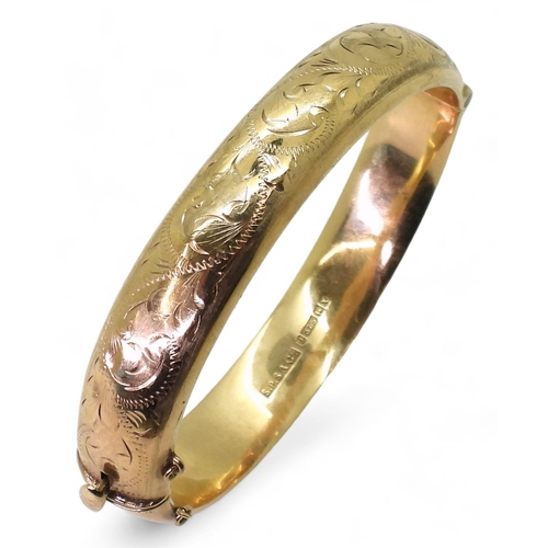 707 - A 9ct gold hollow bangle, with engraved decoration, inner diameter 9.5cm, width 1.2cm, weight 17.9gm... 