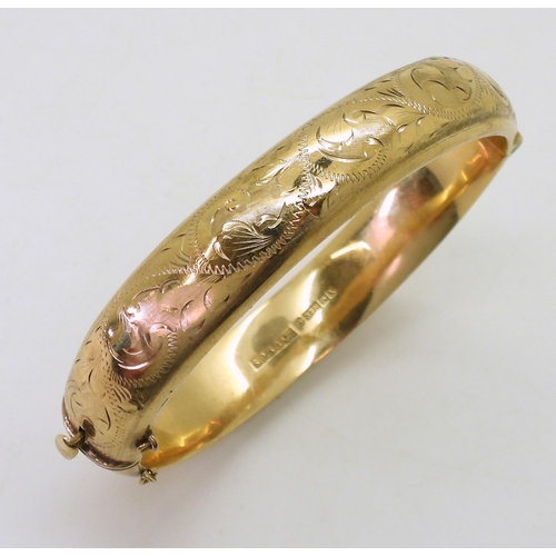 707 - A 9ct gold hollow bangle, with engraved decoration, inner diameter 9.5cm, width 1.2cm, weight 17.9gm... 