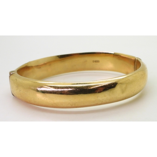 707 - A 9ct gold hollow bangle, with engraved decoration, inner diameter 9.5cm, width 1.2cm, weight 17.9gm... 