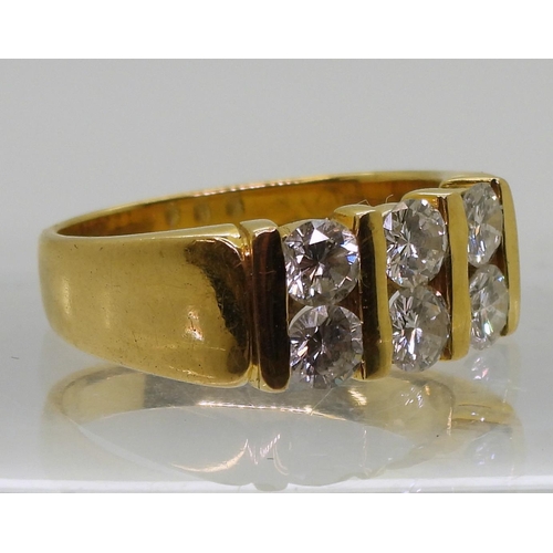 714 - A bright yellow metal ring, stamped 90%, set with six diamonds with a combined diamond total of esti... 