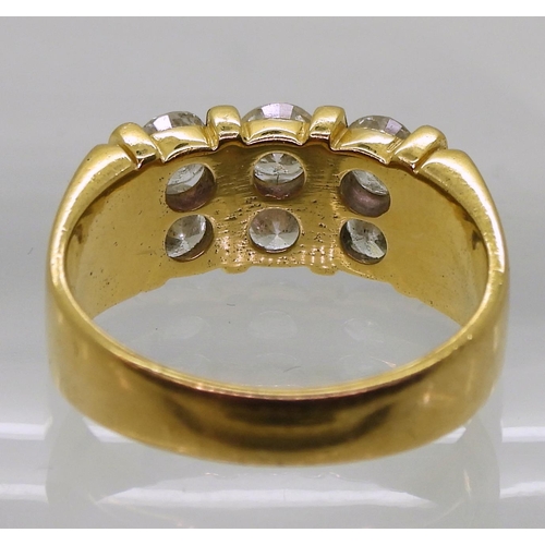 714 - A bright yellow metal ring, stamped 90%, set with six diamonds with a combined diamond total of esti... 