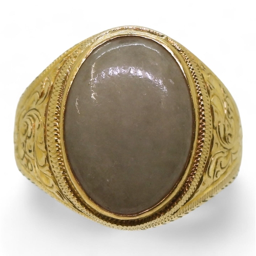 720 - A bright yellow metal signet ring stamped 95%, set with a Chinese green hardstone, with engraved det... 