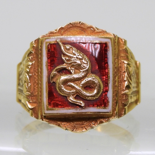 726 - A bright yellow metal ring, with enamelled panel of a serpent, stamped 90% with further Chinese char... 