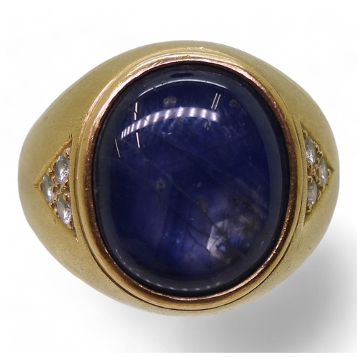 728 - A bright yellow metal ring set with a large opaque sapphire set with estimated approx 0.18cts of bri... 