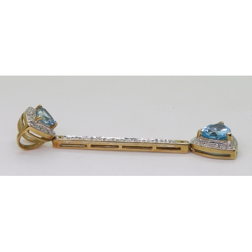 734 - A 9ct gold trilliant cut blue topaz and diamond accent pendant, length 5.3cm, weight 3.9gms