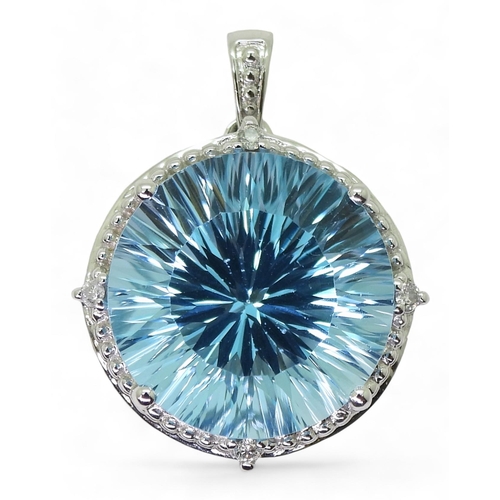 737 - A 9ct white gold fancy cut blue topaz and diamond pendant, diameter approx 2cm, weight 5.4gms