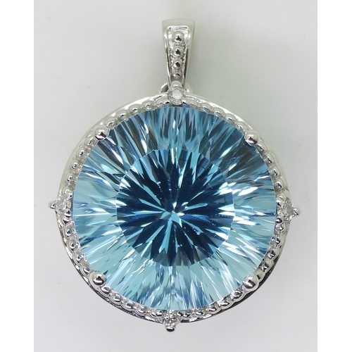 737 - A 9ct white gold fancy cut blue topaz and diamond pendant, diameter approx 2cm, weight 5.4gms