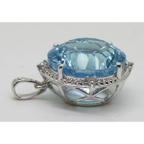 737 - A 9ct white gold fancy cut blue topaz and diamond pendant, diameter approx 2cm, weight 5.4gms