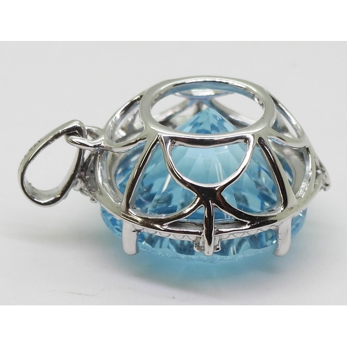 737 - A 9ct white gold fancy cut blue topaz and diamond pendant, diameter approx 2cm, weight 5.4gms