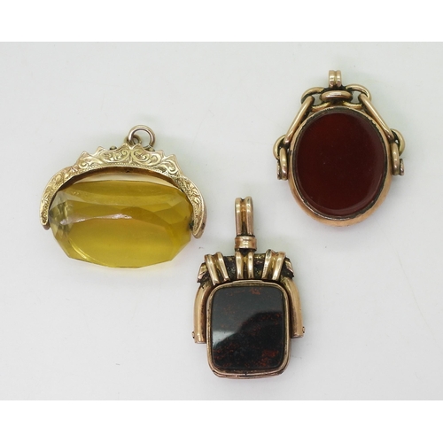 743 - Three vintage fob seals, a yellow glass fob seal in 9ct gold mount, hallmarked Chester 1902, a 9ct c... 