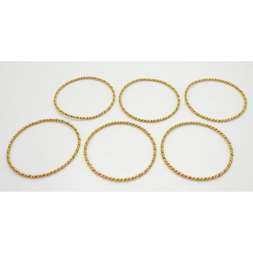 748 - A set of six bright yellow metal bangles from Iran, weight all together 63.1gms