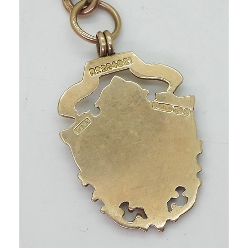 755 - A 9ct rose gold tapered fob chain, with a 9ct gold medallion, length of chain 30cm from clasp to 'T'... 