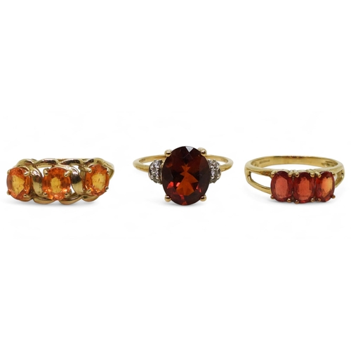 758 - Three 9ct gold gem set rings. A dark orange and clear gem, size Q, together with an orange gem, (pos... 