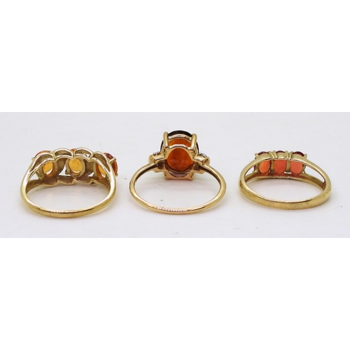 758 - Three 9ct gold gem set rings. A dark orange and clear gem, size Q, together with an orange gem, (pos... 