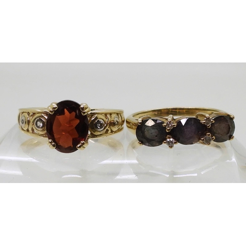 765 - A 9ct gold ring set with three purplish colour change gemstones and diamond accents, size N1/2, and ... 