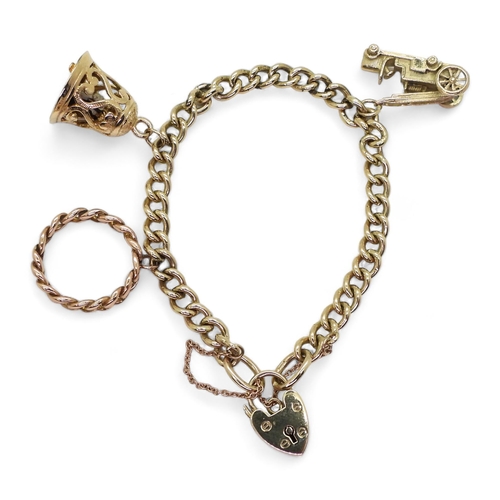 803 - A 9ct gold charm bracelet, with three large 9ct charms and a heart shaped clasp, length of the solid... 