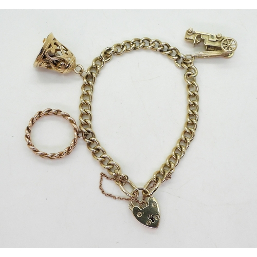 803 - A 9ct gold charm bracelet, with three large 9ct charms and a heart shaped clasp, length of the solid... 