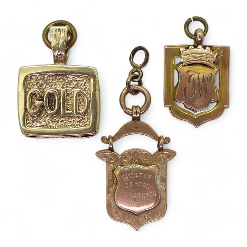 806 - Two 9ct gold medallions and a 9ct 'GOLD' charm, weight all together 43.8gms