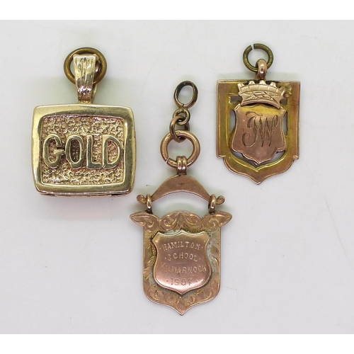 806 - Two 9ct gold medallions and a 9ct 'GOLD' charm, weight all together 43.8gms