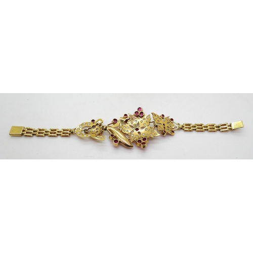 807 - A bright yellow metal Indian bracelet set with pearls and synthetic ruby gems, together with a pair ... 